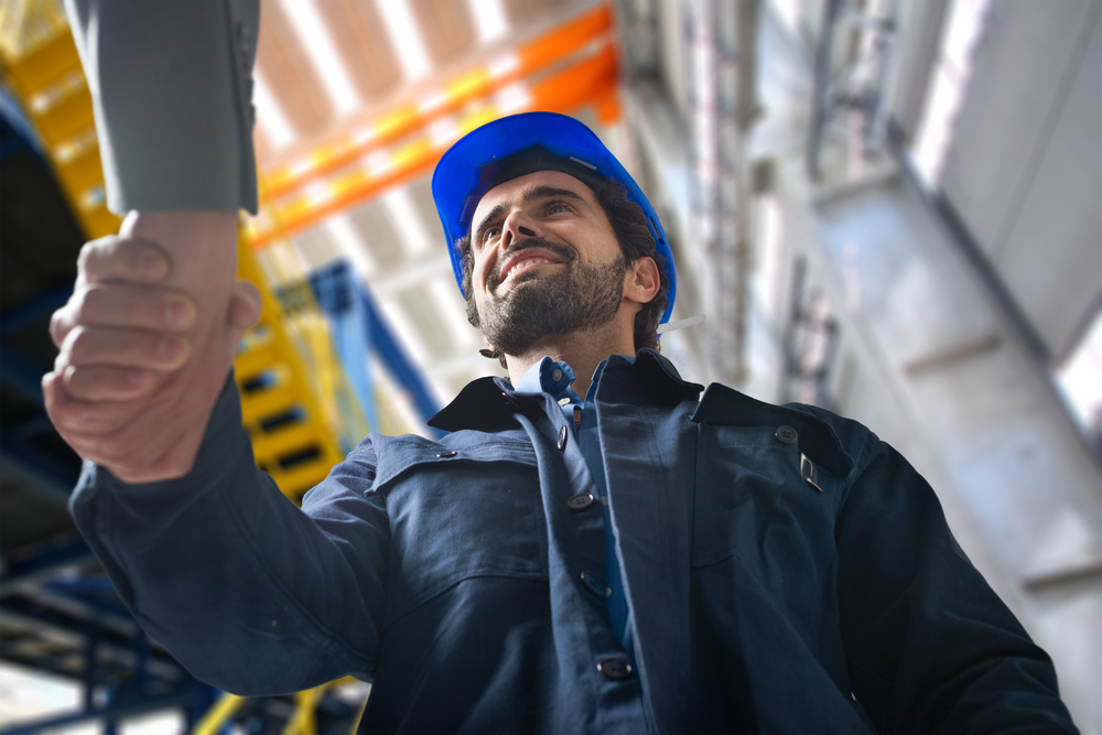 On-site workers in a facility shaking hands