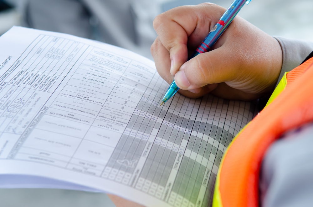 A facility manager reviewing a preventive maintenance checklist